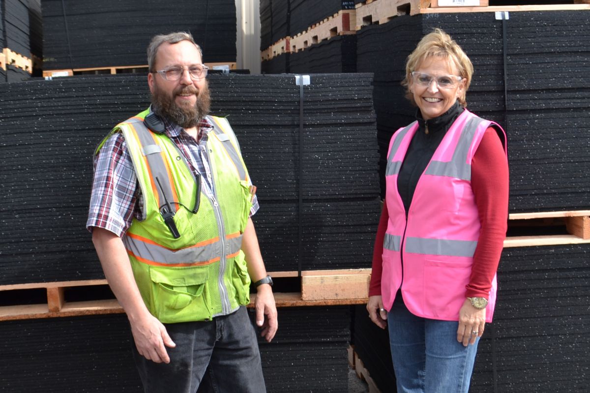 Director of Office Operations, Sue Mathews, and Manufacturing Project Engineer, Dan Dunham stand by product ready to be shipped.